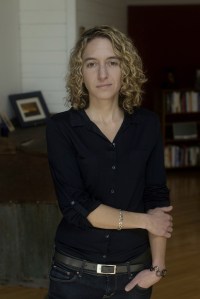 author Kathryn Schulz standing in a room dressed in black